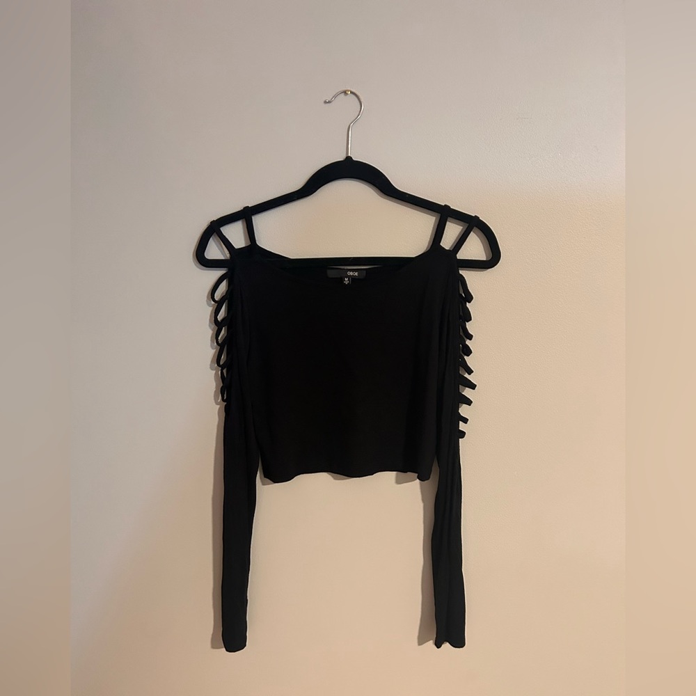 Oboe black long sleeve crop top with cutouts along the sides. Size medium.